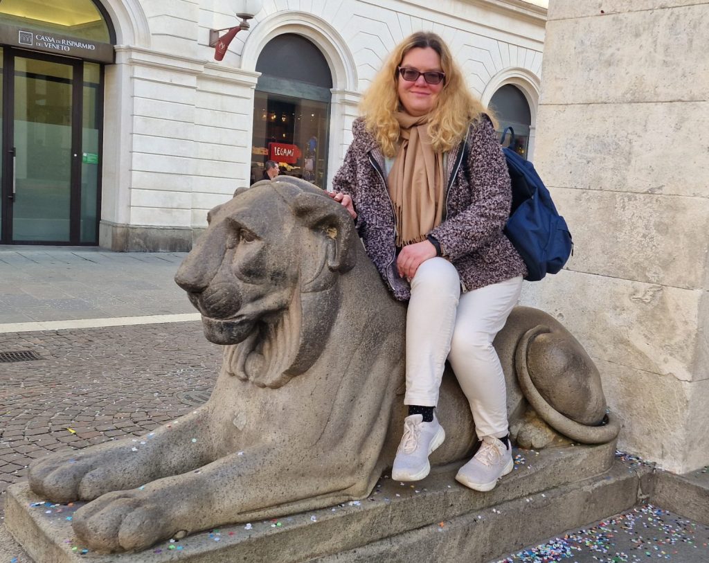 Ieva sitting on a stone lion statue
