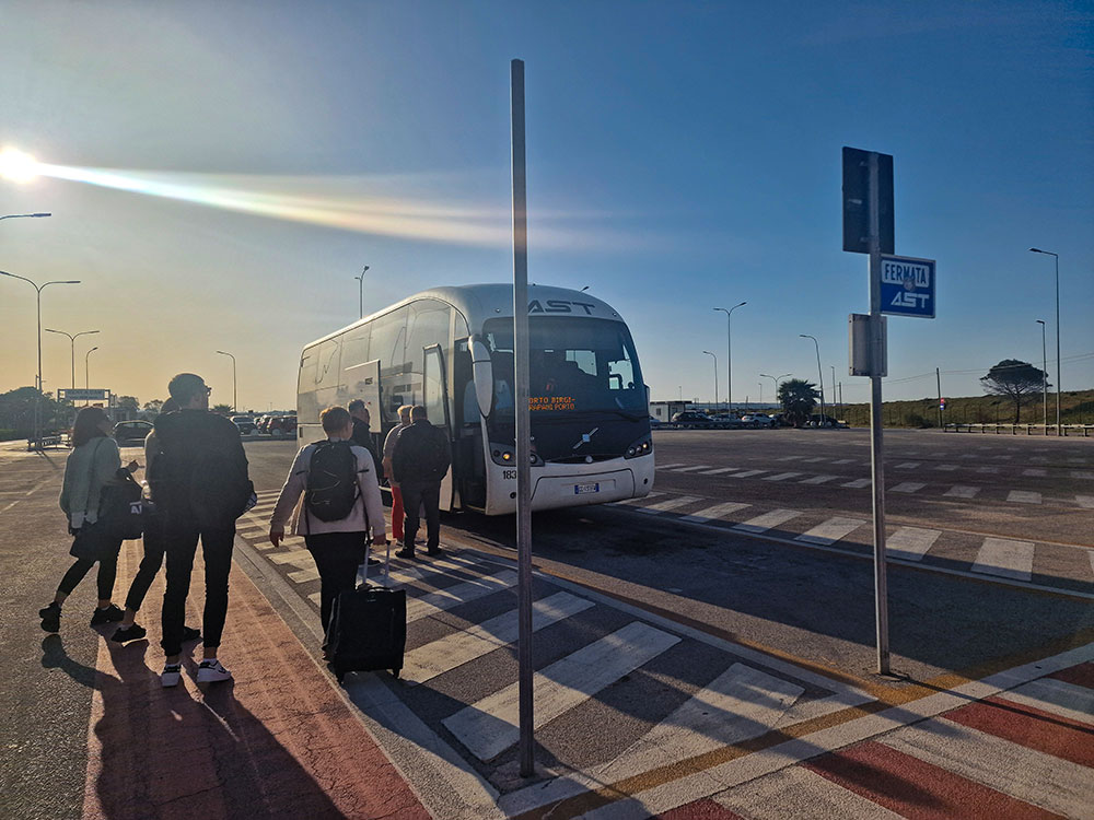 5 travel planning mistakes beginners make 1 People heading to the airport bus, dragging their suitcases behind them