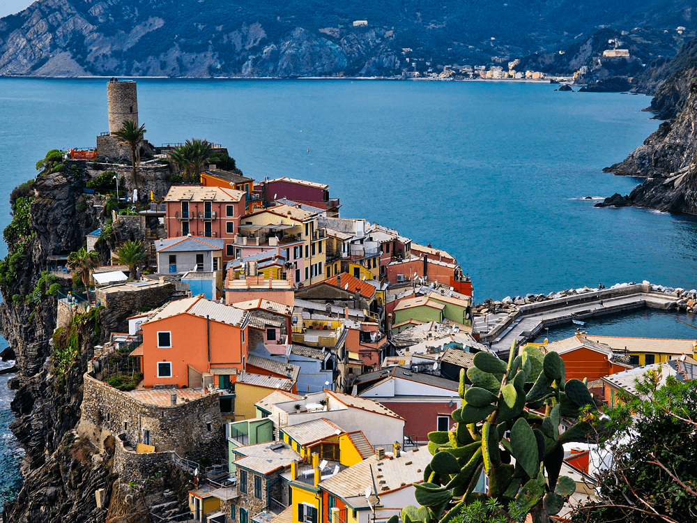 A high viewpoint of Vernazza showing the colourful village, harbour and coastline, photographed while hiking.