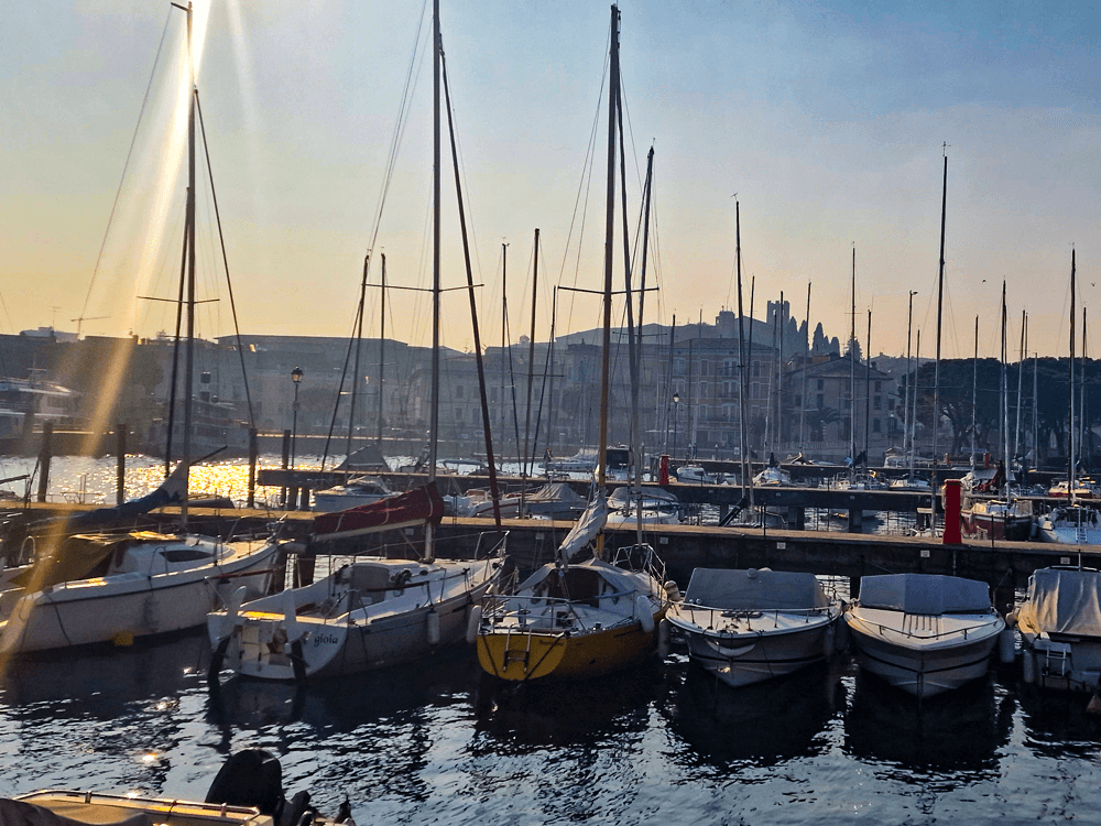 How to reach Lake Garda and its towns by public transport 2 Small boats and sailing vessels moored in the calm harbour of Desenzano del Garda