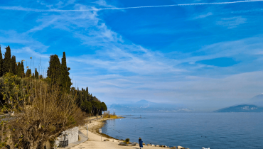 A peaceful lakeside view in Sirmione with clear water and a rocky shoreline