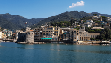 Rapallo’s small seaside castle and colourful houses photographed from the water.